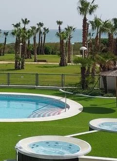 Piscina y jacuzzi con mar al fondo